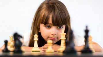 Young girl playing chess